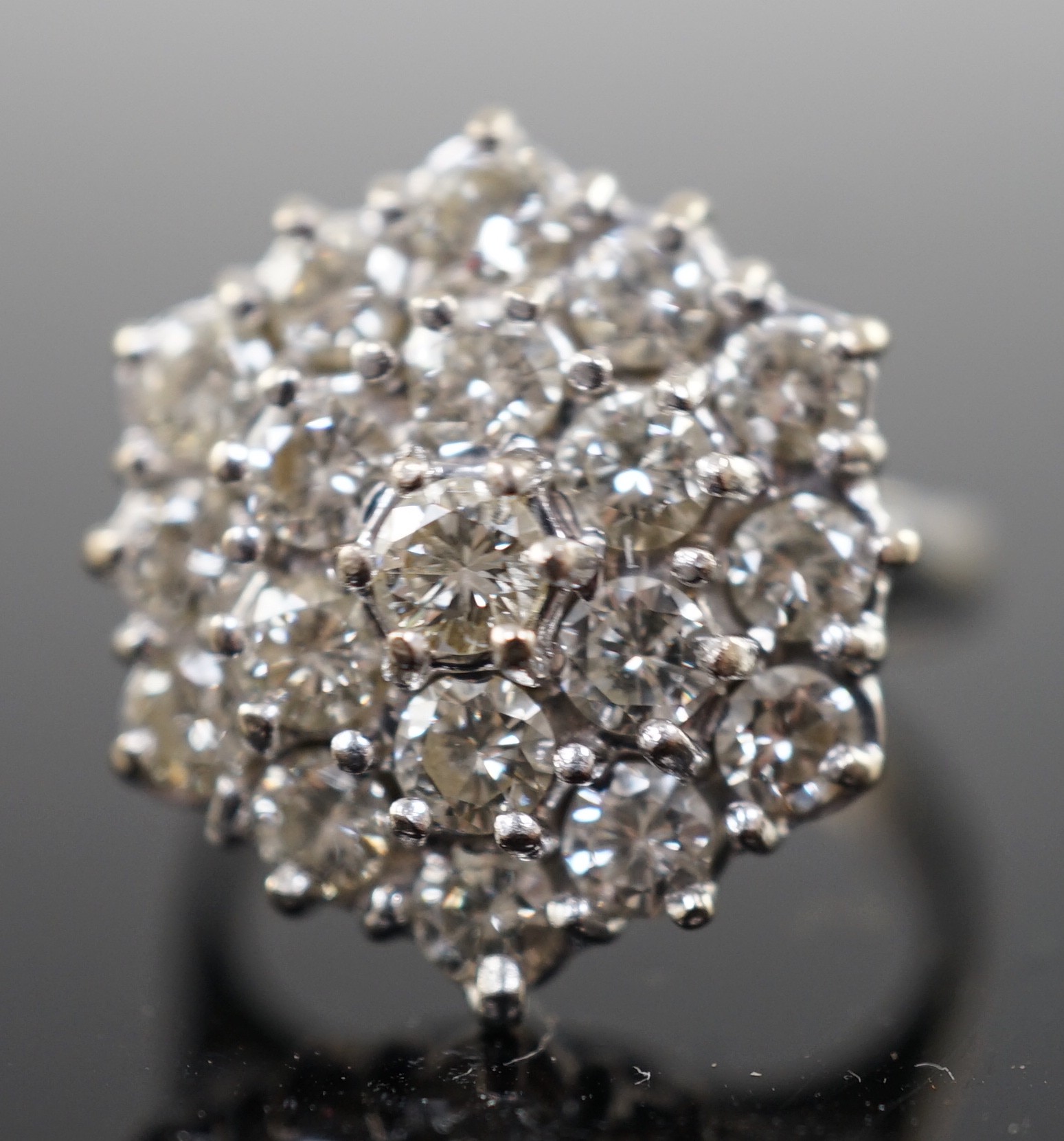 An 18ct white gold and diamond set hexagonal cluster ring